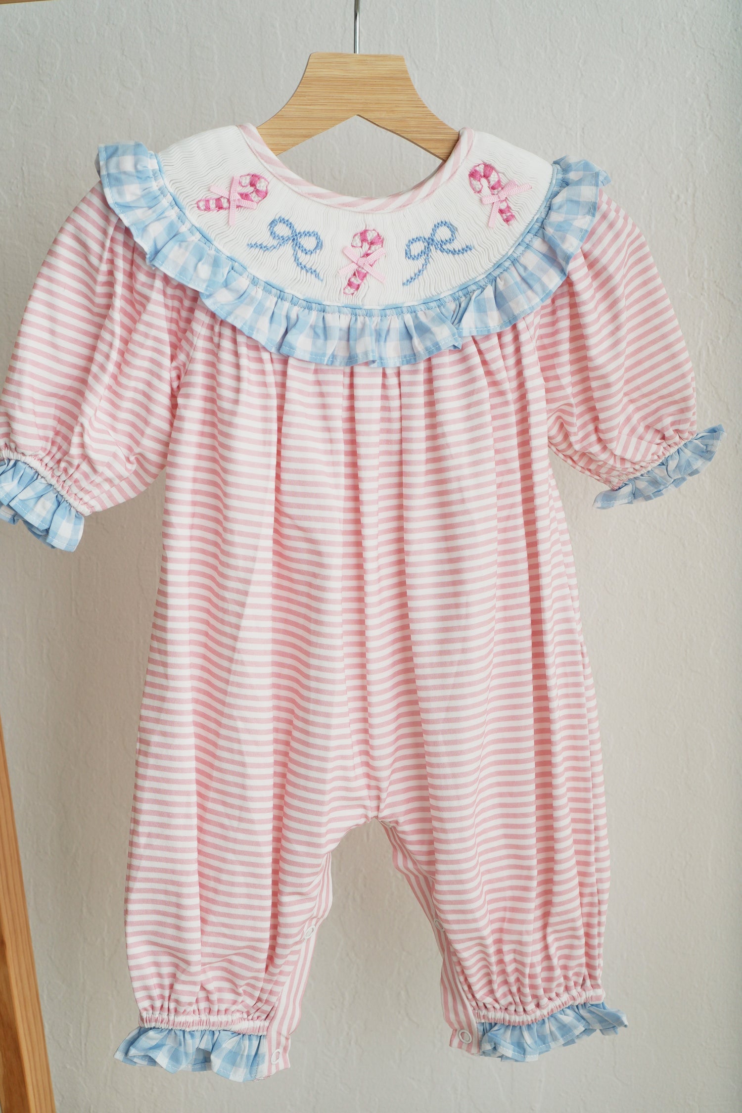 PINK CANDY CANE BOW HAND SMOCKED RUFFLE ROMPER