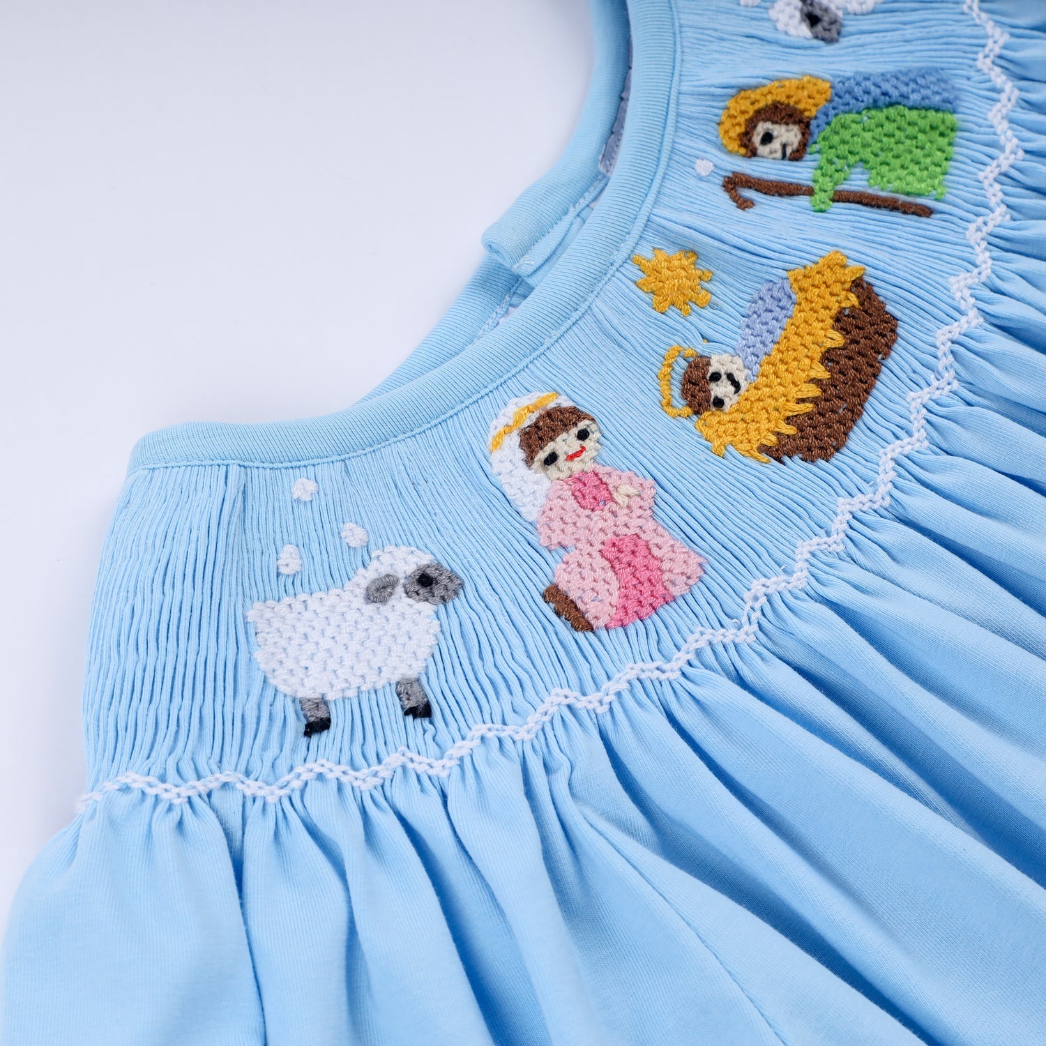 BLUE NATIVITY HAND SMOCKED DRESS